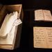 Des gants dans une boite et des carnets de note manuscrits.